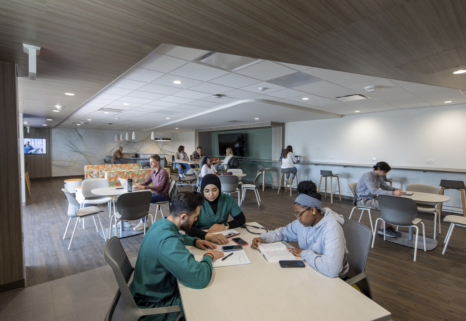 Photo of students studying and working in the student commons